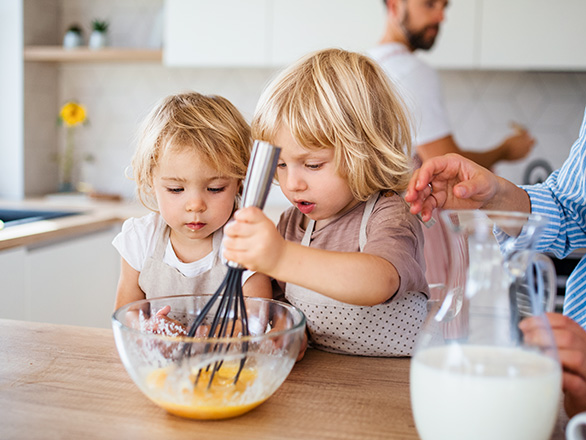 two little girls learn how to cook