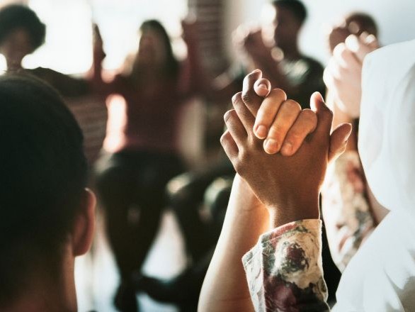 Group of people holding hands.