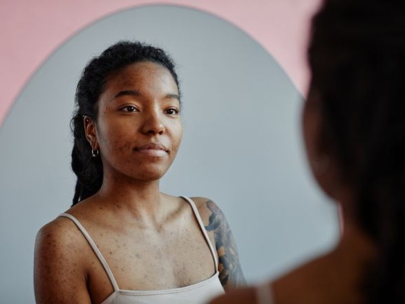 Woman looking in mirror