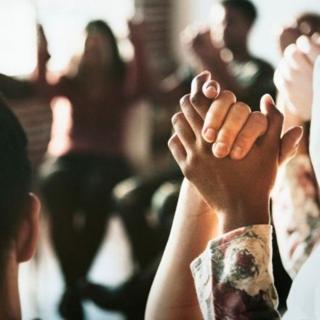group of people holding hands.