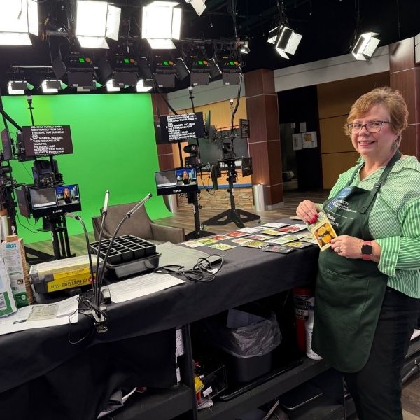 Master Gardener volunteer in front of news cameras