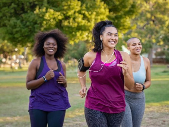 Three women running together. 