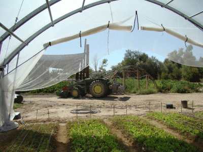 Tractor in front of a hoop house