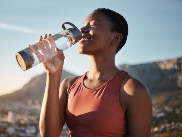 Women drinking from water bottle
