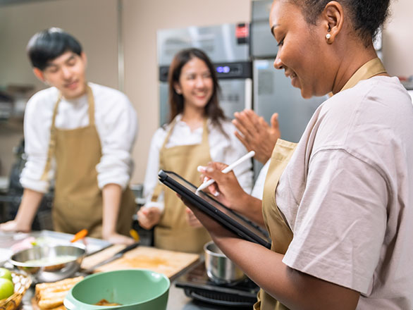Instructor helping room full of adults with food plans