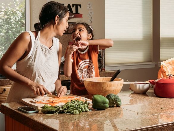 A woman and child cooking together.