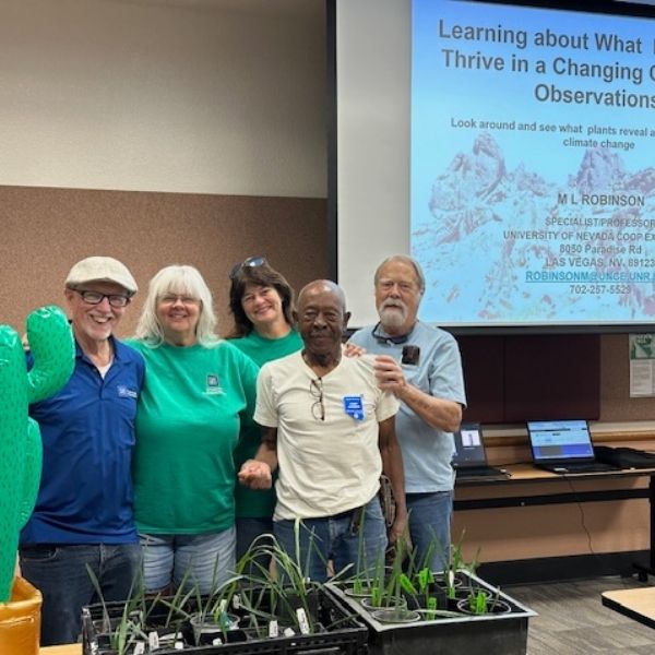Master Gardeners posing with ML Robinson in front of presentation at Laughlin Library