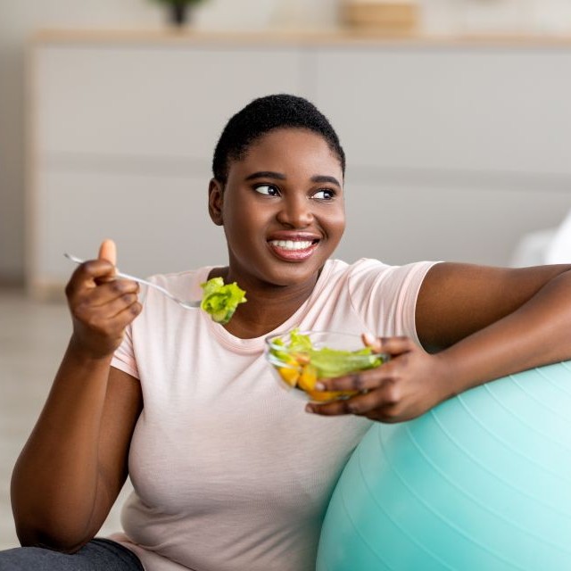 Woman eating a salad.
