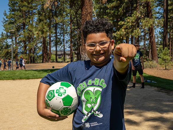 4H camper with soccer ball