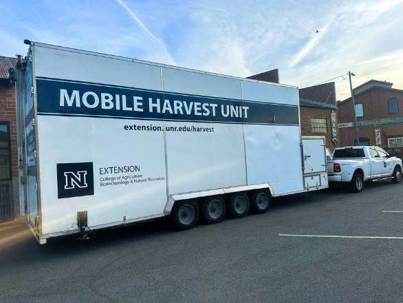 Image of the Mobile Harvest Unit being pulled by an Extension vehicle