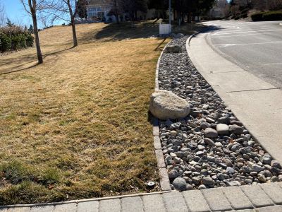 A 2-foot wide buffer strip of rock mulch between the lawn and the sidewalk or street.