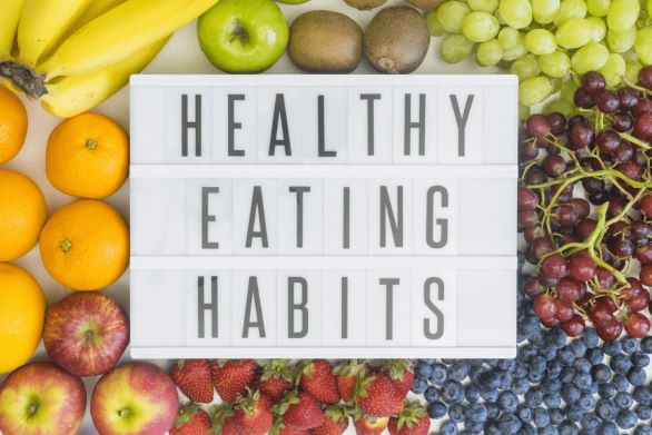 The words Healthy Eating Habits in the middle of many fruits and vegetables