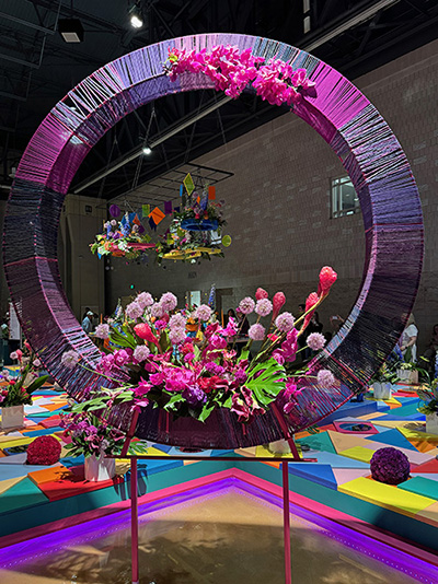 A large pink and purple circular decoration  with pink and purple flowers in the center.