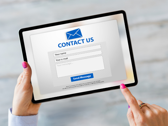 A tablet showing a "CONTACT US" website form.